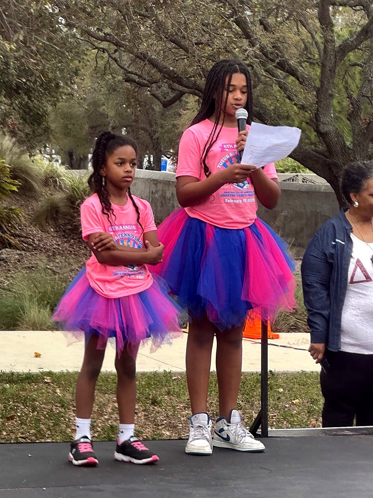 Two girls speaking on stage