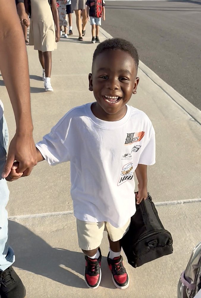 A child smiling on the first day of school