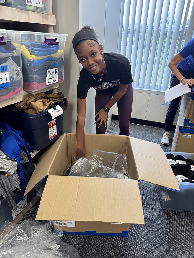 A teen unpacking donations