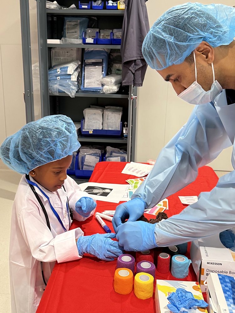 A child learning to bandage at a hospital visit